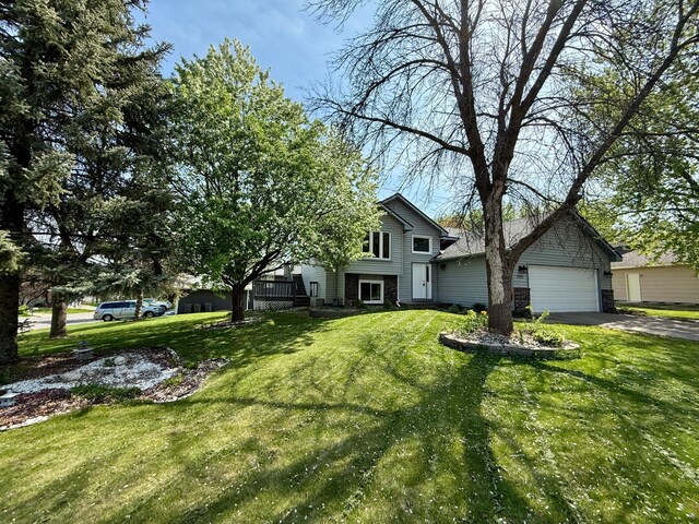14303 Utica Ave, Savage, MN 55378 - split level home with a front lawn, a garage, and driveway