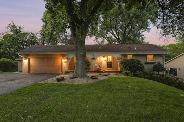 6788 147th St W, Savage, MN 55378 - ranch-style home featuring driveway, brick siding, a garage, and a yard