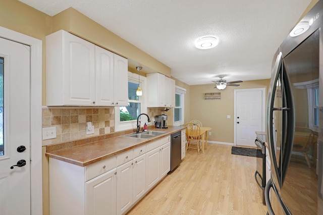 6788 147th St W, Savage, MN 55378 - kitchen with stainless steel appliances, ceiling fan, white cabinets, decorative backsplash, and light wood-style floors