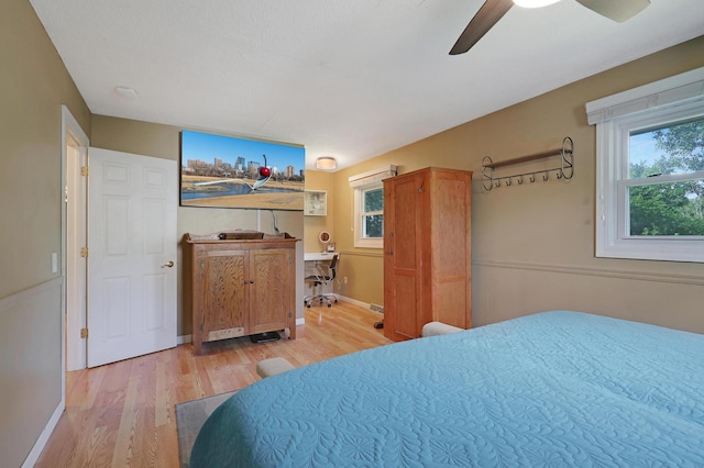 6788 147th St W, Savage, MN 55378 - bedroom featuring light wood-style flooring and a ceiling fan