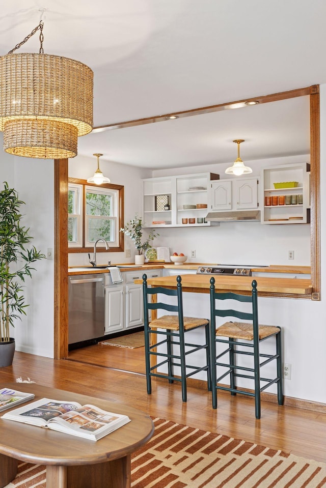 301 3rd St S Unit 302, Stillwater, MN 55082 - kitchen with open shelves, stainless steel dishwasher, butcher block countertops, light wood finished floors, and under cabinet range hood