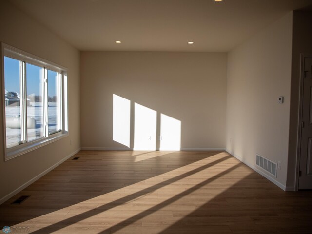 302 Neuman Blvd, Colfax, ND 58018 - spare room featuring wood finished floors and recessed lighting