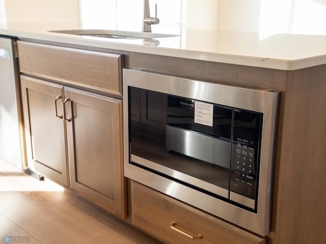 302 Neuman Blvd, Colfax, ND 58018 - kitchen view of stainless steel microwave and a sink
