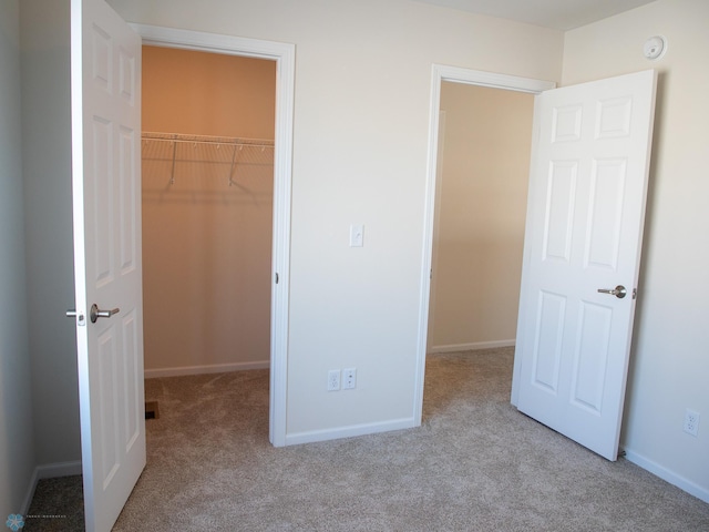 302 Neuman Blvd, Colfax, ND 58018 - unfurnished bedroom featuring a walk in closet, carpet floors, and a closet