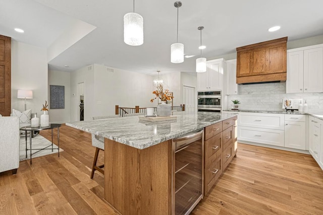 738 Ensconced Way, Chaska, MN 55318 - kitchen featuring beverage cooler, backsplash, light wood-style flooring, white cabinets, and recessed lighting