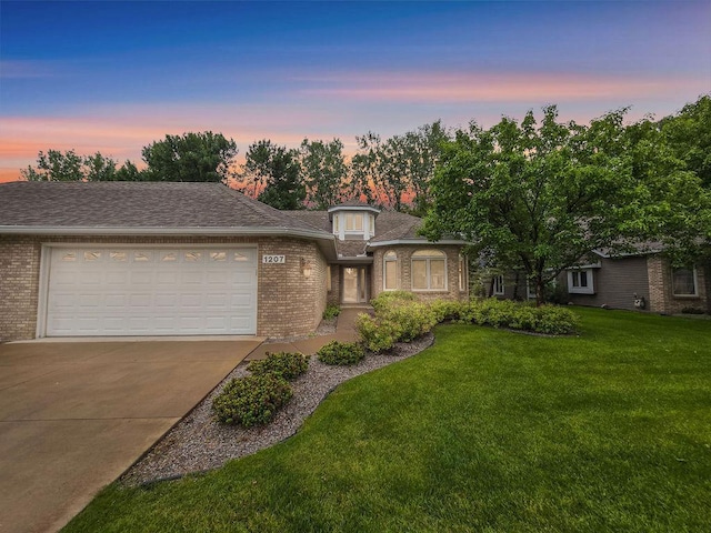 1207 Silverthorn Ct, Shoreview, MN 55126 - view of front of home featuring brick siding, driveway, an attached garage, and a lawn