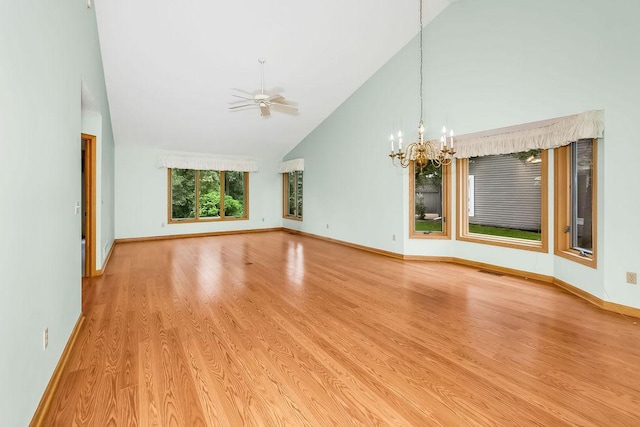 1207 Silverthorn Ct, Shoreview, MN 55126 - empty room with a chandelier, light wood finished floors, high vaulted ceiling, and a ceiling fan