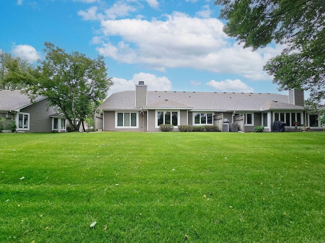 1207 Silverthorn Ct, Shoreview, MN 55126 - back of property featuring a chimney and a lawn