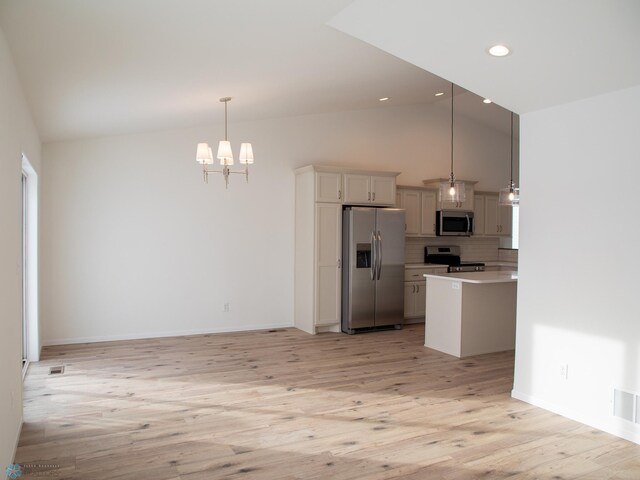 6310 83rd Ave S, Horace, ND 58047 - kitchen featuring stainless steel appliances, light wood-type flooring, light countertops, a chandelier, and backsplash