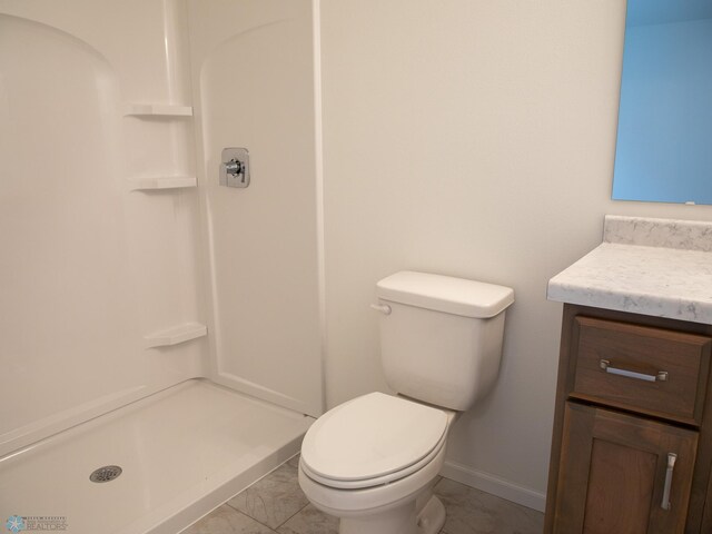 6310 83rd Ave S, Horace, ND 58047 - bathroom featuring vanity, a shower, and marble look tile flooring