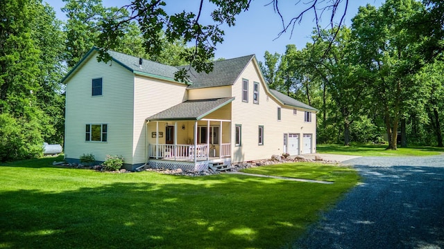 5936 Roosevelt Rd SE, Bemidji, MN 56601 - view of front of home featuring a porch, asphalt driveway, an attached garage, roof with shingles, and a front yard