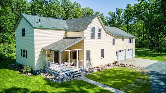 5936 Roosevelt Rd SE, Bemidji, MN 56601 - back of house with a porch, driveway, a garage, a lawn, and roof with shingles