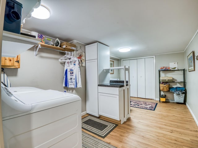 5936 Roosevelt Rd SE, Bemidji, MN 56601 - laundry room featuring cabinet space, light wood-style flooring, and washing machine and dryer