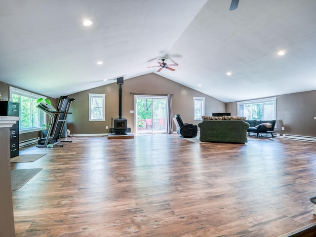 5936 Roosevelt Rd SE, Bemidji, MN 56601 - living room with a wood stove, a ceiling fan, vaulted ceiling, healthy amount of natural light, and recessed lighting
