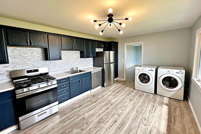 7165 US Highway 169, Garrison, MN 56450 - kitchen featuring stainless steel appliances, washing machine and clothes dryer, light countertops, and light wood-style flooring