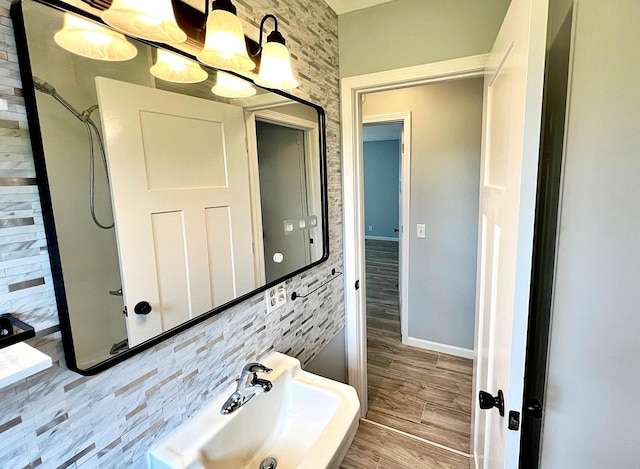 7165 US Highway 169, Garrison, MN 56450 - bathroom with a chandelier, wood finished floors, and tile walls