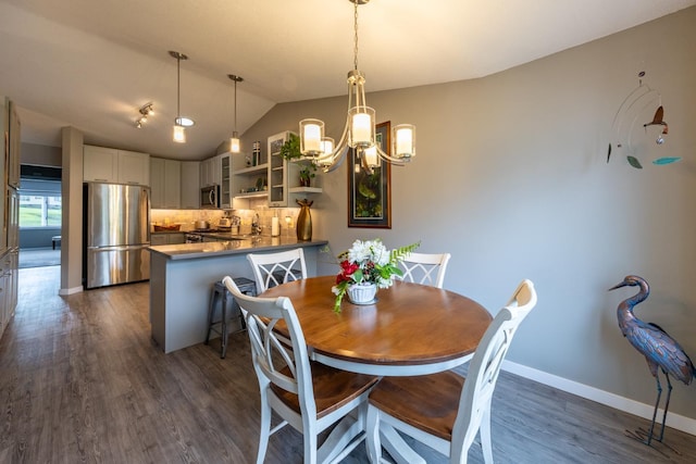 609 Main St E, Wabasha, MN 55981 - dining room featuring a chandelier, lofted ceiling, and dark wood-style floors
