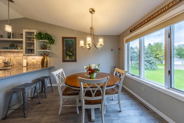 609 Main St E, Wabasha, MN 55981 - dining space with wood finished floors, a chandelier, and lofted ceiling
