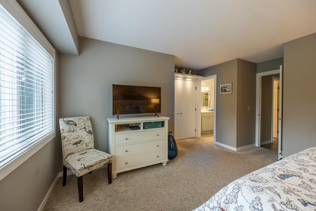 609 Main St E, Wabasha, MN 55981 - bedroom featuring light colored carpet, multiple windows, and ensuite bath