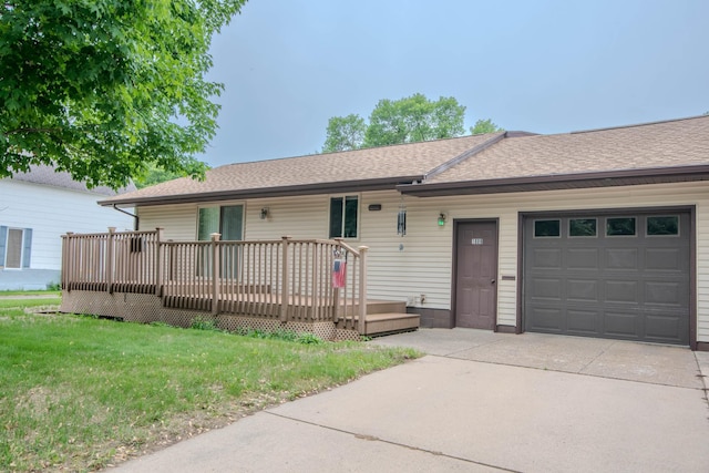 1009 7th St NE, Little Falls, MN 56345 - ranch-style home featuring an attached garage, driveway, a shingled roof, a deck, and a front lawn