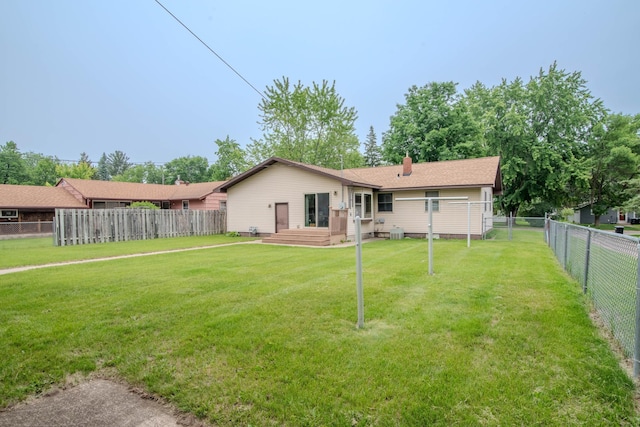 1009 7th St NE, Little Falls, MN 56345 - rear view of property with a fenced backyard and a chimney