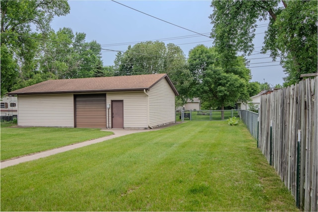 1009 7th St NE, Little Falls, MN 56345 - fenced backyard featuring a garage and an outdoor structure