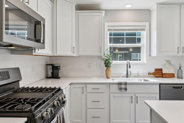 9462 Bridle Way, Victoria, MN 55386 - kitchen with appliances with stainless steel finishes, decorative backsplash, white cabinets, and light countertops