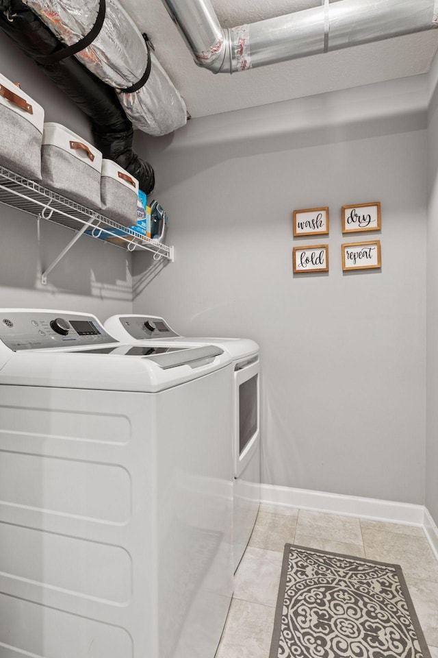 9462 Bridle Way, Victoria, MN 55386 - laundry room with washer and dryer and light tile patterned flooring