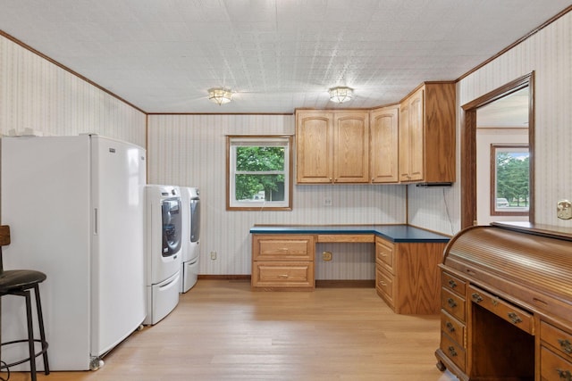 704 Highland Dr, New Prague, MN 56071 - kitchen with freestanding refrigerator, washer and dryer, wallpapered walls, light wood-style floors, and plenty of natural light