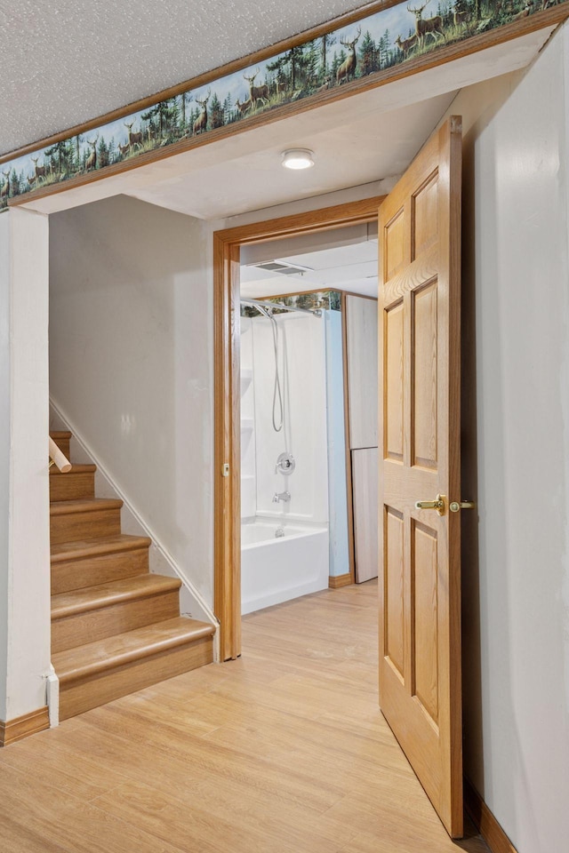 704 Highland Dr, New Prague, MN 56071 - hallway with light wood finished floors and stairway