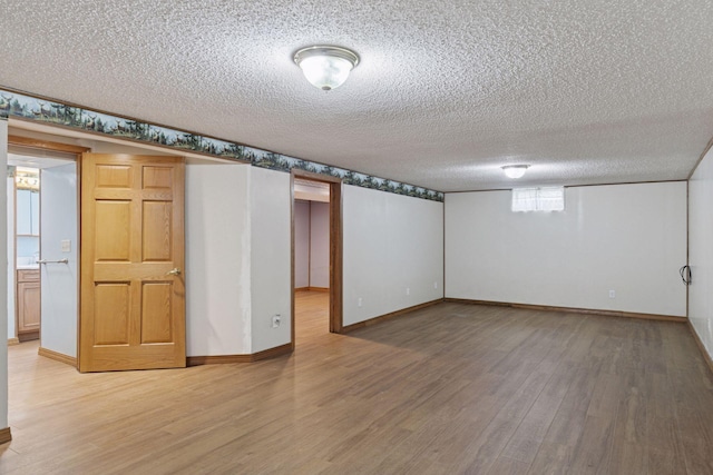 704 Highland Dr, New Prague, MN 56071 - below grade area with a textured ceiling and light wood-style floors
