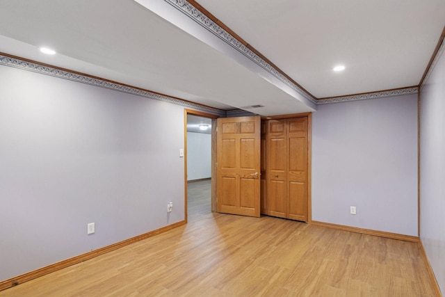 704 Highland Dr, New Prague, MN 56071 - finished basement with light wood-type flooring, recessed lighting, and ornamental molding
