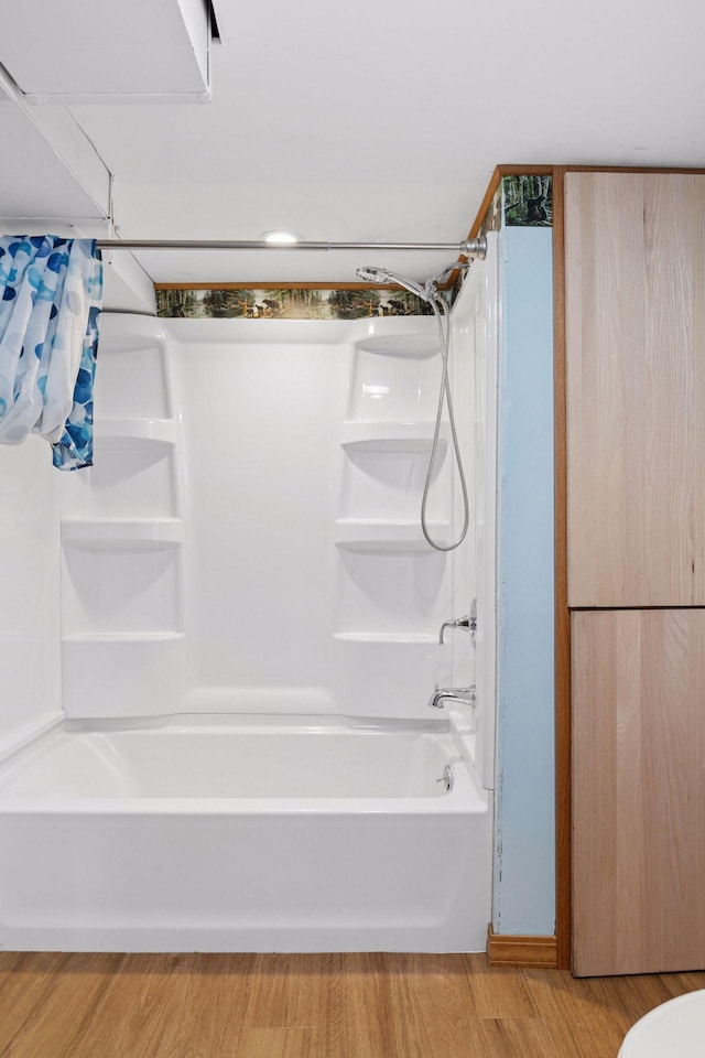 704 Highland Dr, New Prague, MN 56071 - bathroom with shower / tub combination and wood finished floors