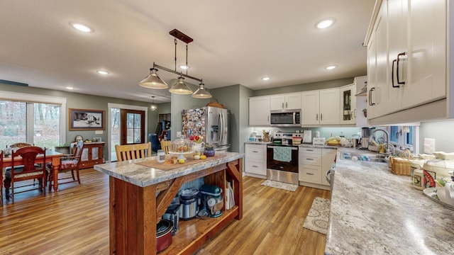 31340 Indigo Rd, Fountain, MN 55935 - kitchen with stainless steel appliances, light wood-style floors, white cabinetry, pendant lighting, and recessed lighting