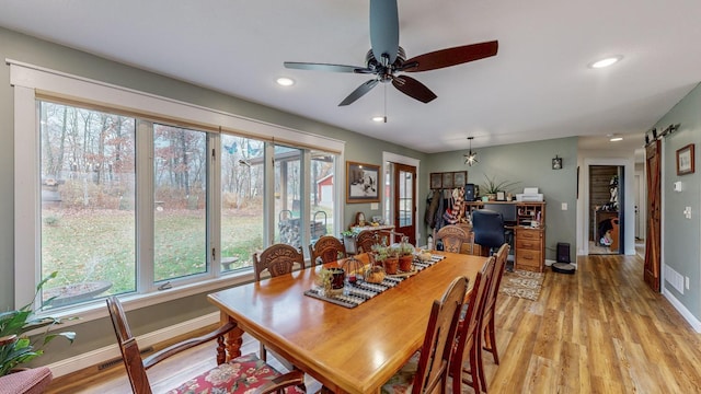 31340 Indigo Rd, Fountain, MN 55935 - dining area featuring light wood finished floors, plenty of natural light, a ceiling fan, recessed lighting, and a barn door