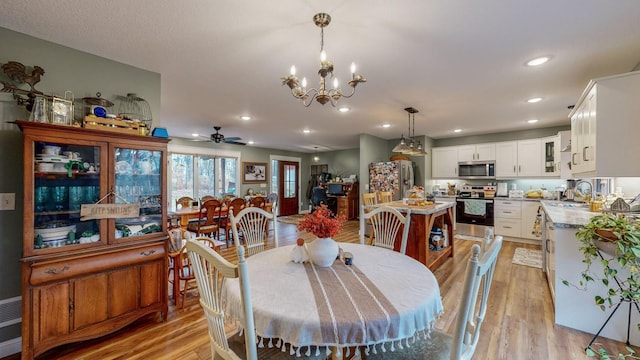 31340 Indigo Rd, Fountain, MN 55935 - dining area featuring light wood-type flooring, a chandelier, a ceiling fan, and recessed lighting