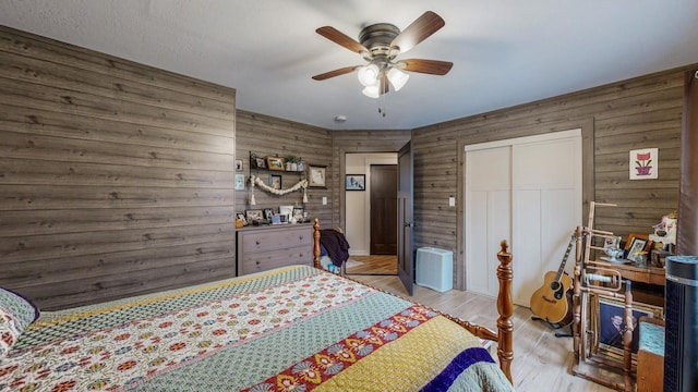 31340 Indigo Rd, Fountain, MN 55935 - bedroom with wooden walls, a closet, wood finished floors, and a ceiling fan