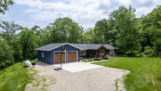 31340 Indigo Rd, Fountain, MN 55935 - ranch-style house with driveway, an attached garage, a front lawn, a porch, and a view of trees