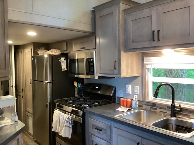 14275 Schuelke Beach Rd NW, Miltona, MN 56354 - kitchen with appliances with stainless steel finishes, backsplash, gray cabinets, dark countertops, and recessed lighting