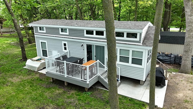 14275 Schuelke Beach Rd NW, Miltona, MN 56354 - rear view of house with roof with shingles, a deck, and a lawn