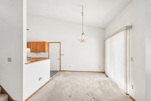 2513 Sumac Rdg, White Bear Lake, MN 55110 - unfurnished dining area featuring light colored carpet and vaulted ceiling