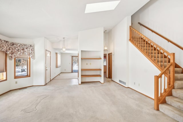 2513 Sumac Rdg, White Bear Lake, MN 55110 - unfurnished living room with stairway, light colored carpet, and a skylight