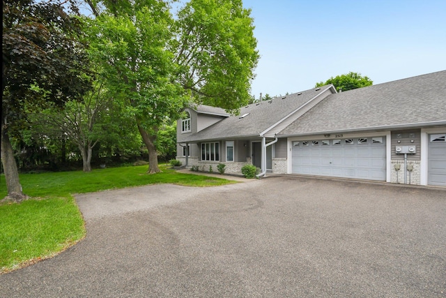 2513 Sumac Rdg, White Bear Lake, MN 55110 - view of front of home featuring a shingled roof, a front yard, an attached garage, and asphalt driveway