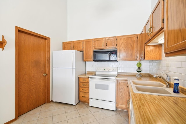2513 Sumac Rdg, White Bear Lake, MN 55110 - kitchen with white appliances, light countertops, tasteful backsplash, light tile patterned floors, and a towering ceiling