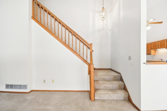 2513 Sumac Rdg, White Bear Lake, MN 55110 - staircase with carpet floors and ceiling fan
