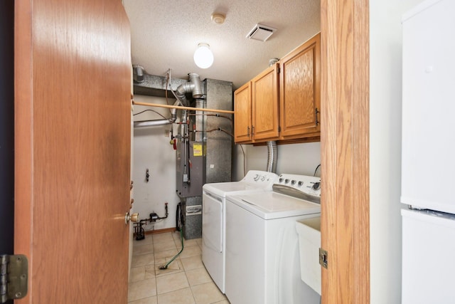 2513 Sumac Rdg, White Bear Lake, MN 55110 - washroom with washer and dryer, cabinet space, light tile patterned floors, and a textured ceiling