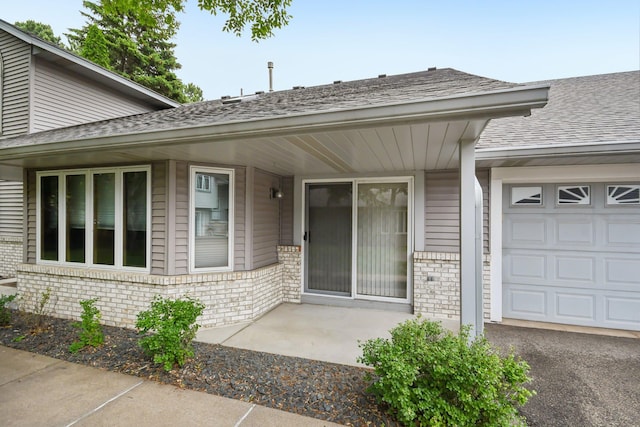 2513 Sumac Rdg, White Bear Lake, MN 55110 - view of exterior entry featuring brick siding, roof with shingles, and a garage