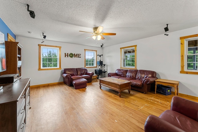 42118 Lowden Ave, Sunrise Twp, MN 55032 - living room featuring light wood-style floors, a ceiling fan, and a textured ceiling