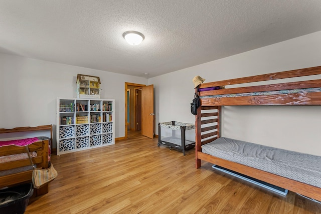 42118 Lowden Ave, Sunrise Twp, MN 55032 - bedroom featuring wood finished floors and a textured ceiling