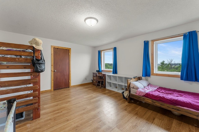 42118 Lowden Ave, Sunrise Twp, MN 55032 - bedroom with light wood-type flooring and a textured ceiling